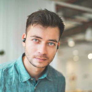 man wearing green collared top